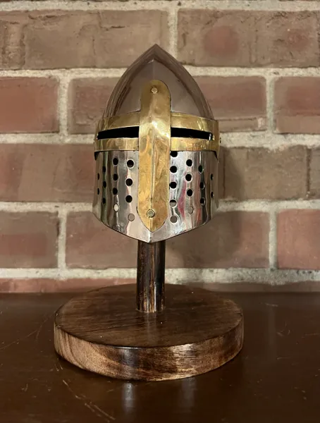 MINIATURE 8" MEDIEVAL KNIGHT HELMET WITH STAND - SUGARLOAF This is a great desktop decor for all medieval era fans. Replica Knight Sugarloaf helmet is made of steel with wood stand. Has the authentic details on the real thing. Handmade. Measurements: 8" Tall (Helmet) Material: Steel Construction Helmet & Wood Stand Finish: Polished Chrome